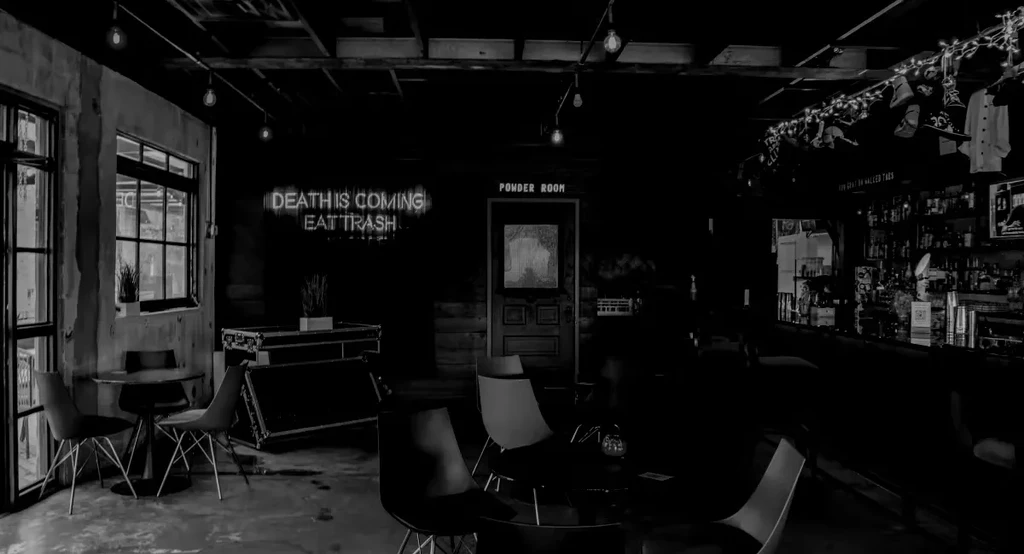 Black and white interior of an urban bar or restaurant.
