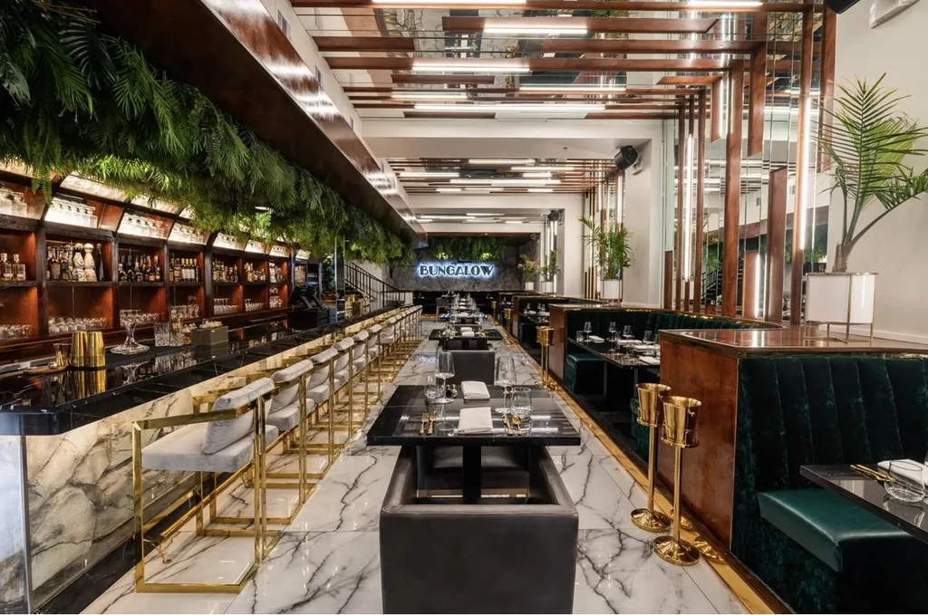 Luxurious restaurant interior with a bar, dining area, and marble floors.
