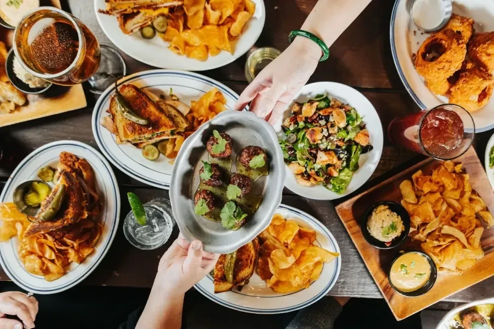 Overhead shot of a table laden with various food and drinks.