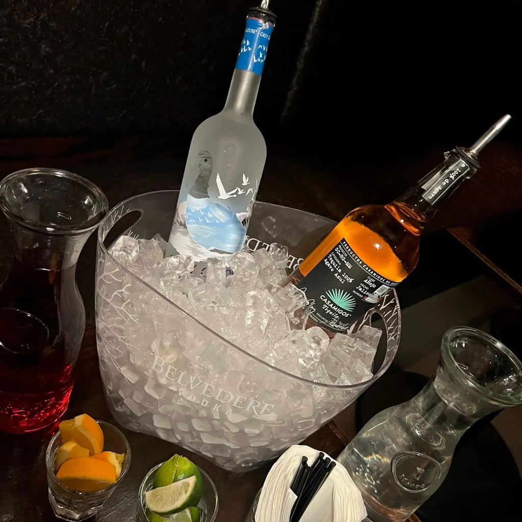 Ice bucket with vodka and tequila, carafes, fruit slices, napkins.
