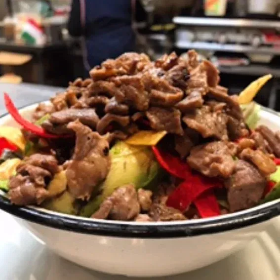 Bowl of diced meat, avocado, red pepper, and chips.