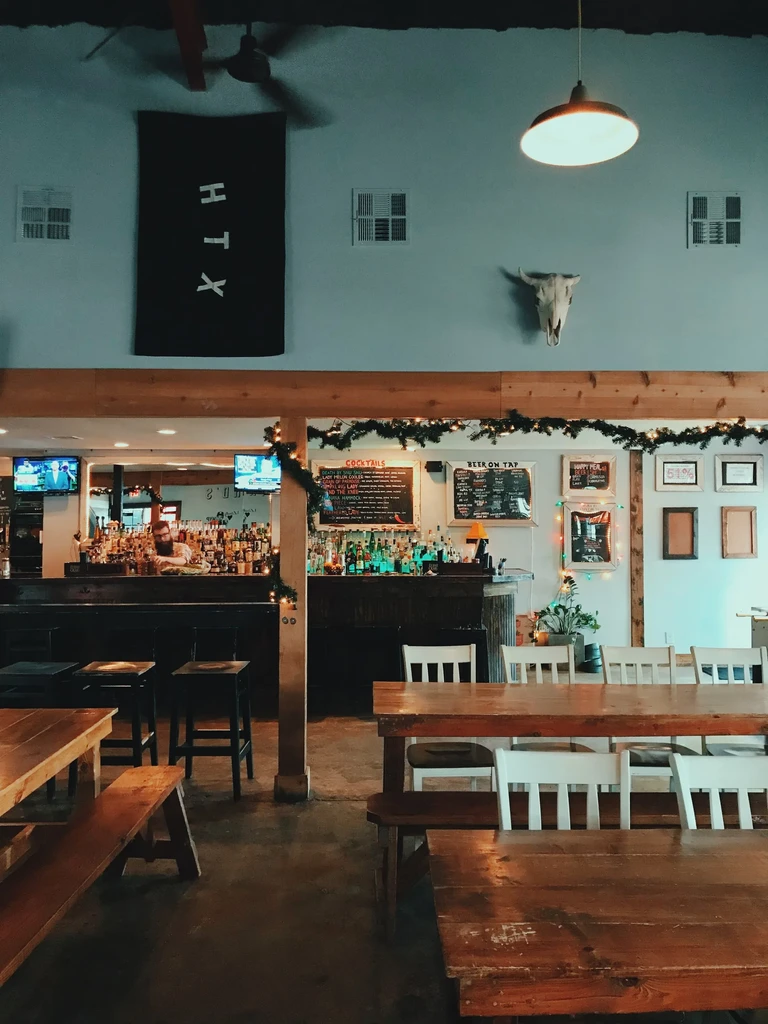 Interior of a casual restaurant or bar with a stocked bar.