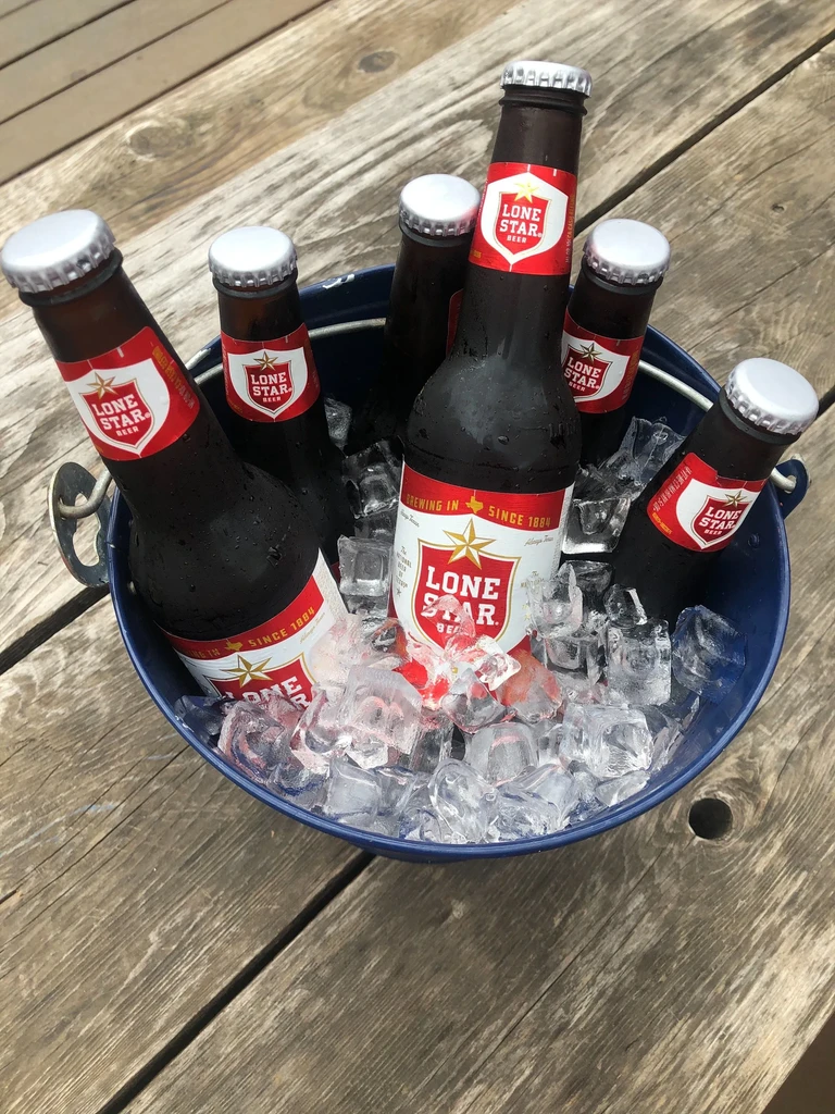 Blue bucket with ice and six bottles of Lone Star Beer.
