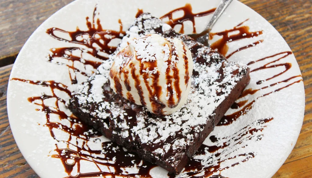 Dark chocolate brownie with vanilla ice cream and chocolate sauce.