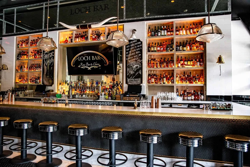 Interior of Loch Bar, showing the bar, bottles, and decor.
