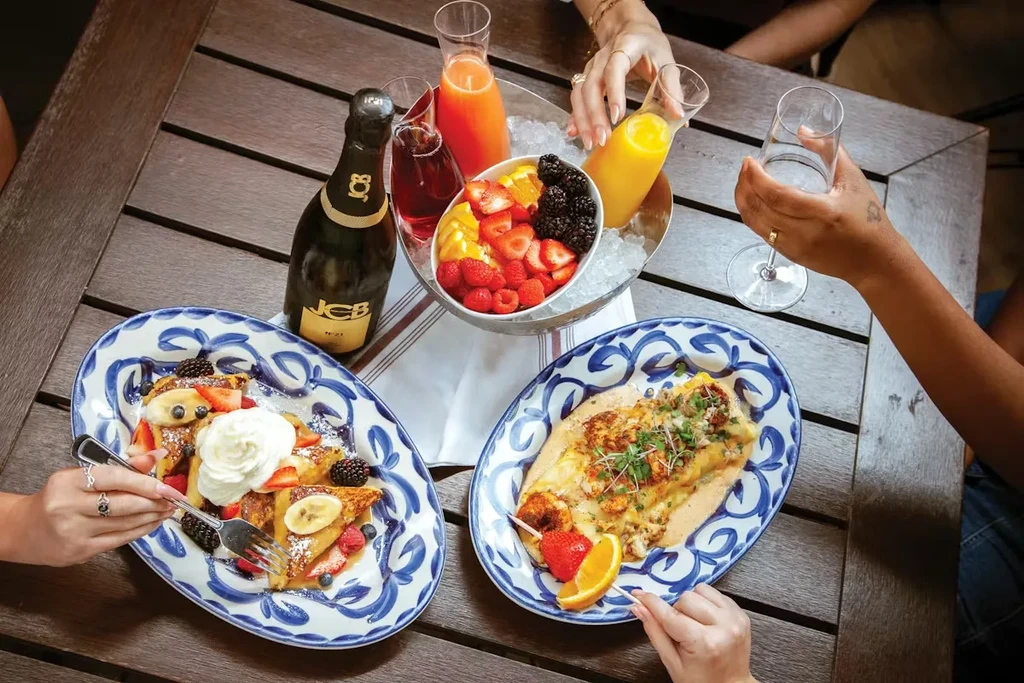 Overhead view of a brunch spread on a wooden table.