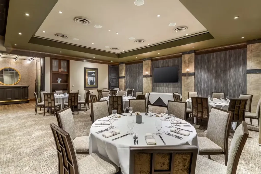 Elegant restaurant dining room with set tables and decorative elements.