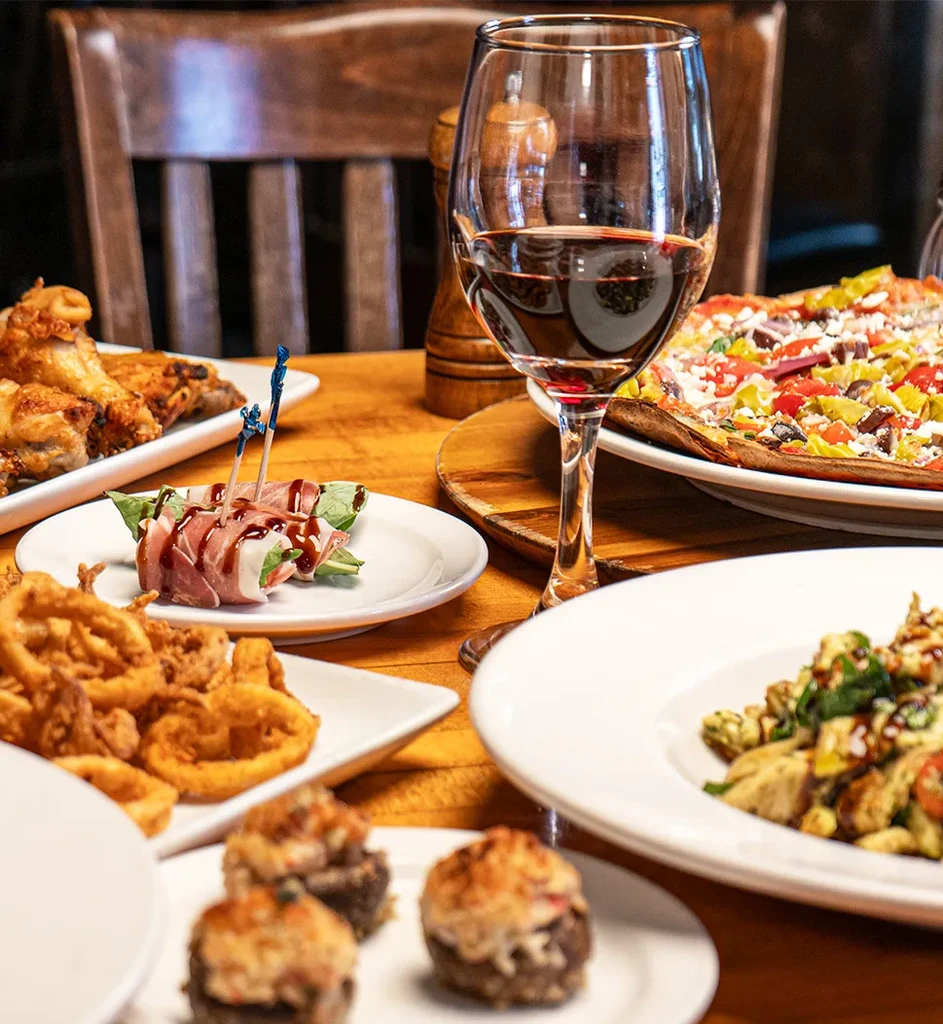 High-angle shot of a wooden table laden with various dishes.