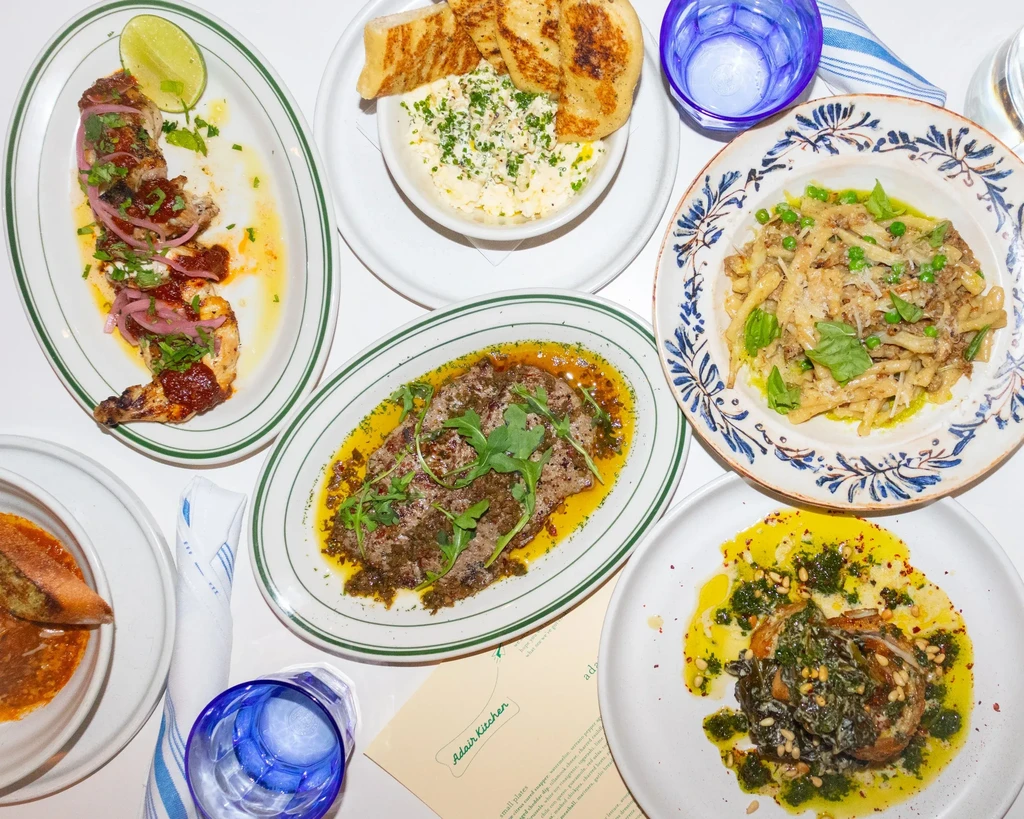 Flat lay of various dishes, beverages, and an Adair Kitchen menu.