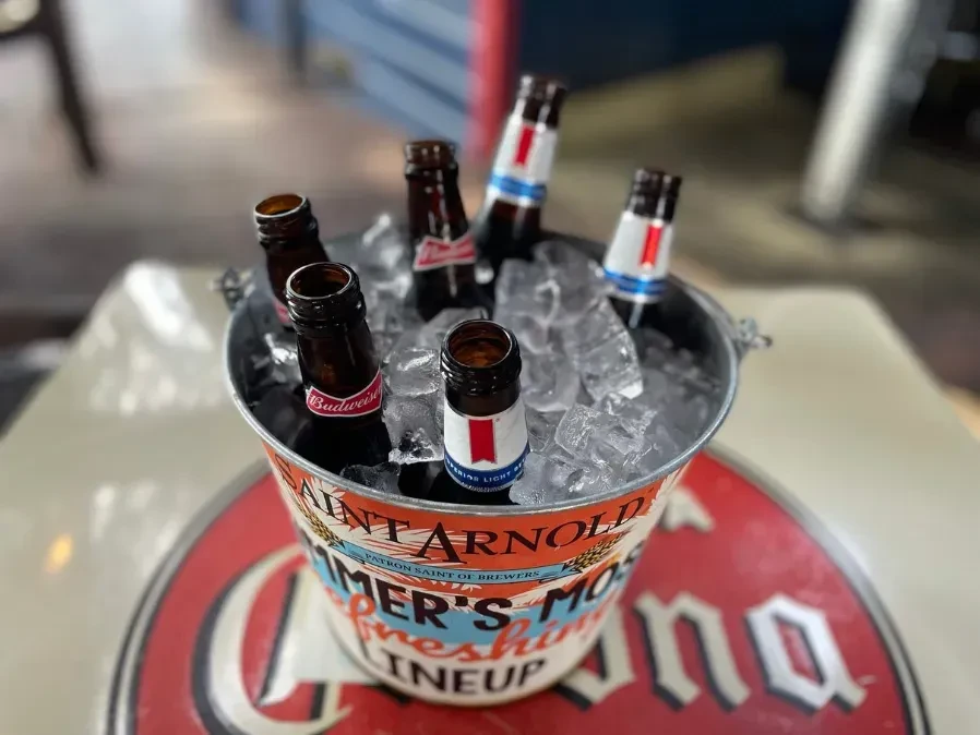 Metal bucket with ice and various beer bottles.