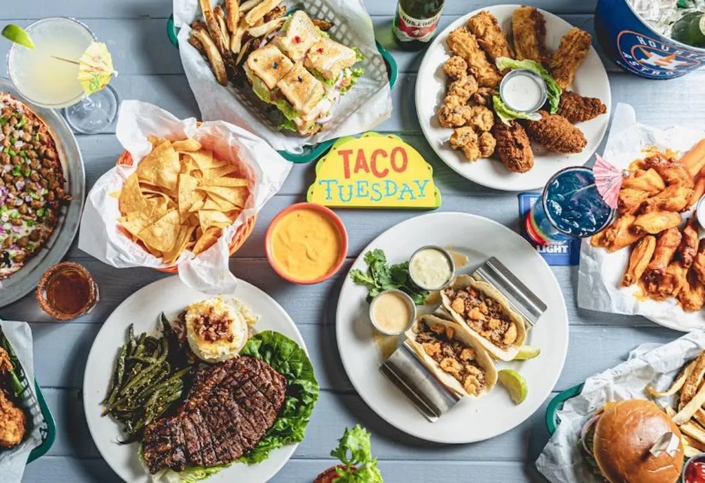 Overhead shot of a table laden with varied food and drinks.