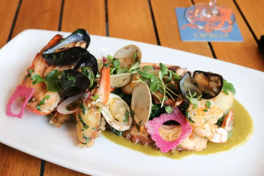 Beautifully plated seafood dish with mussels, clams, shrimp, and octopus.