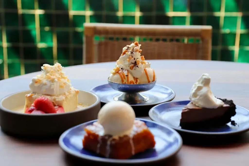 Four desserts: strawberry cake, ice cream sundae, pudding, chocolate pie.