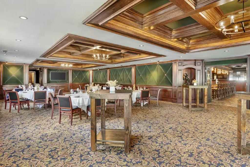 Elegant restaurant dining room with set tables and traditional decor.