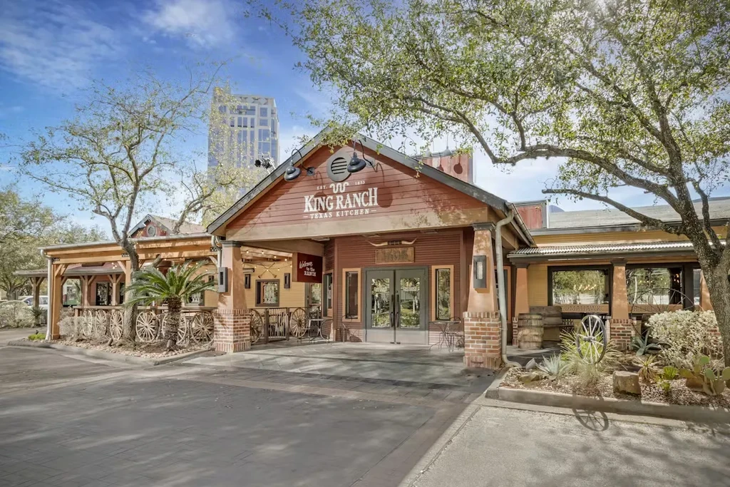 Exterior of King Ranch Texas Kitchen under a partly cloudy sky.