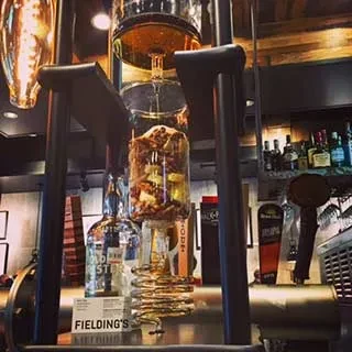 Intricate alcohol infusion system with botanicals at Fielding's bar.