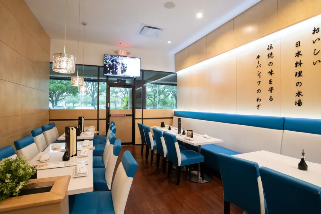 Modern Japanese restaurant interior with booth seating and pendant lights.