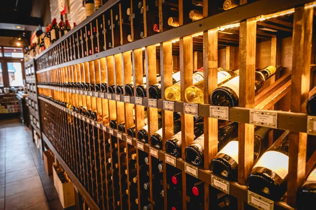 Wooden wine rack filled with numerous bottles of wine.