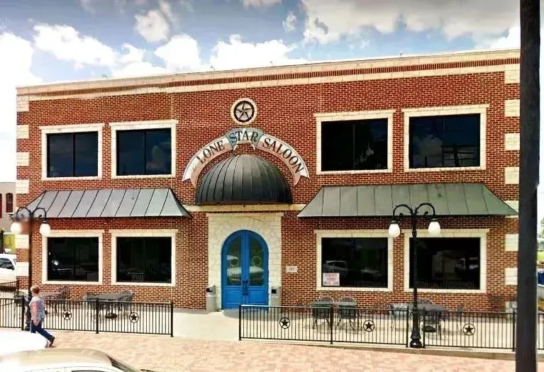 Exterior of Lone Star Saloon, a two-story brick building.