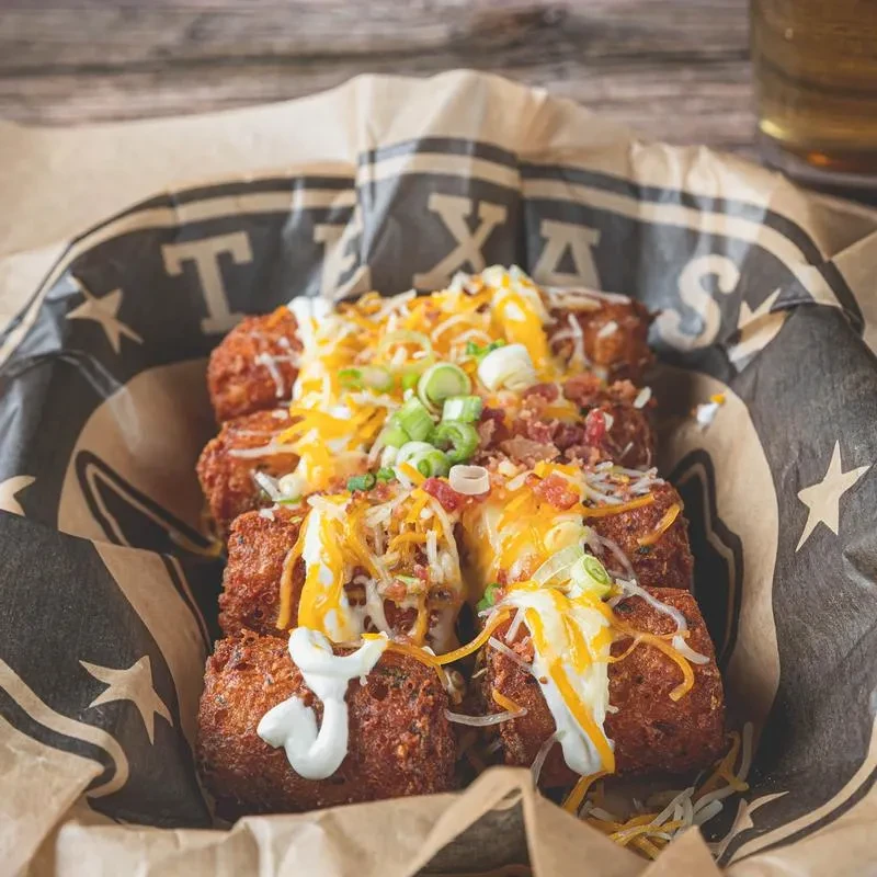 Crispy loaded tater tots with melted cheese, bacon, green onions.