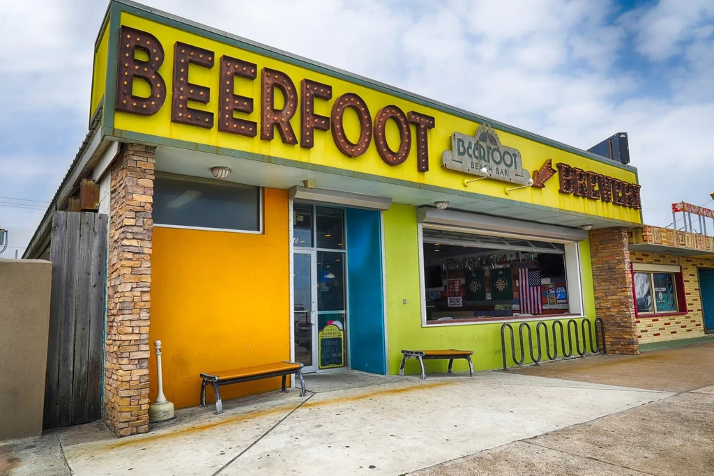 Colorful Beerfoot Beach Bar and Brewery with stone pillars.