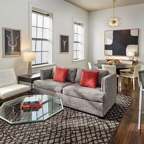 Modern room featuring a grey sectional sofa and dining area.