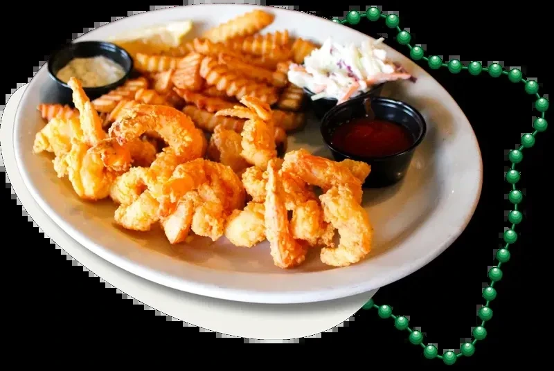 Fried shrimp and fries with coleslaw, sauces, lemon, and Mardi Gras beads.