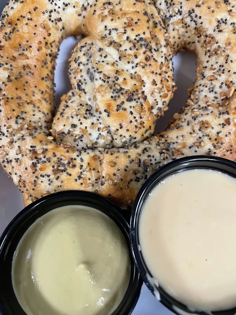 Golden-brown everything bagel pretzel served with two creamy dipping sauces.