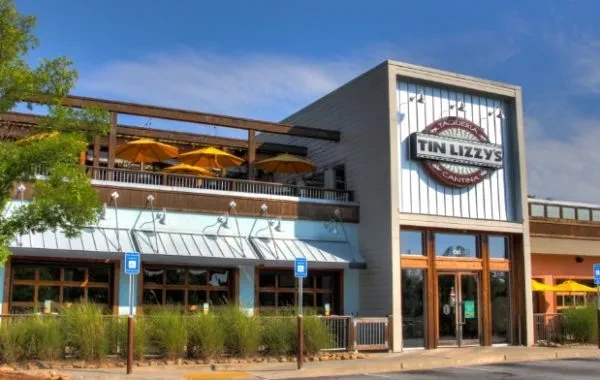 Modern multi-story Tin Lizzy's Cantina exterior with a shaded upper patio.