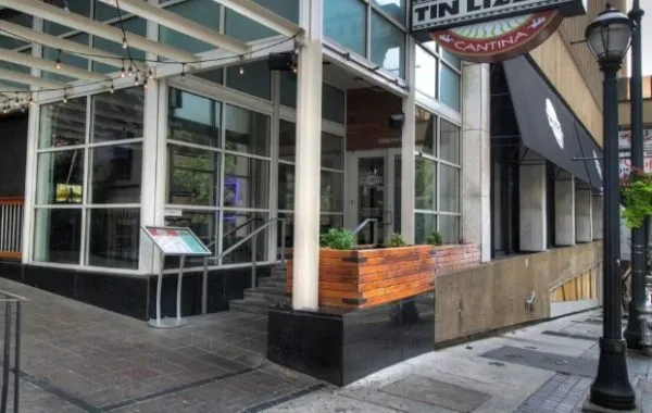 Facade of Tin Lizzy's Cantina featuring windows, entrance, string lights, and awning.