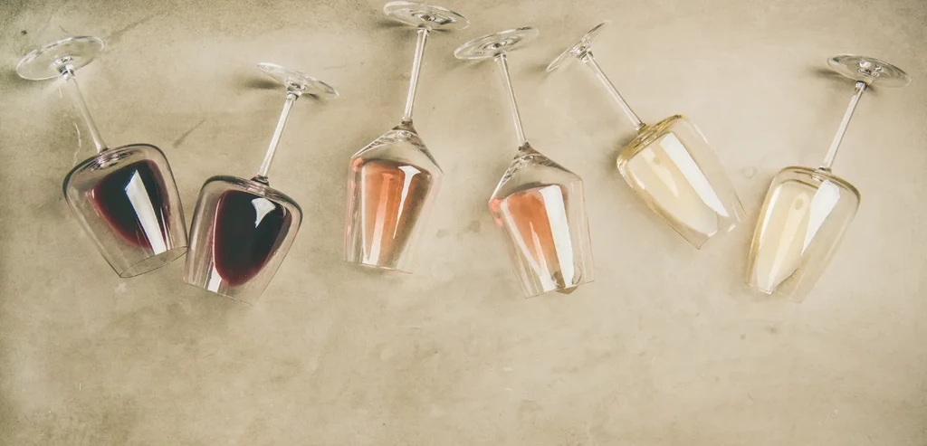 Six wine glasses arranged diagonally with red, rosé, and white wines.