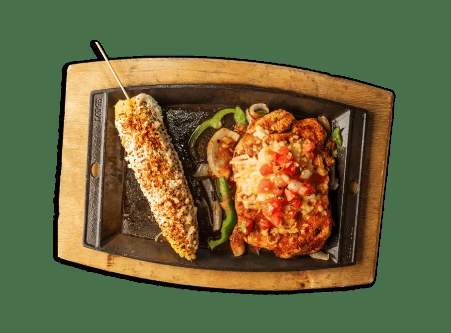 Skillet: Elote, grilled chicken with melted cheese, tomatoes, peppers, onions.