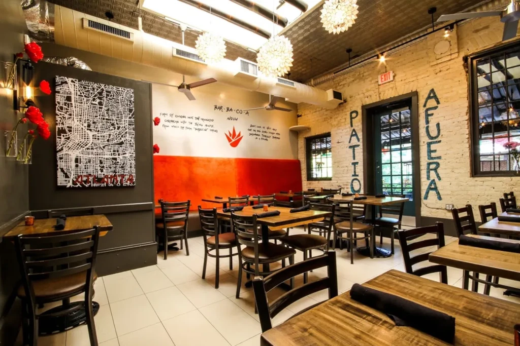 Empty modern restaurant dining area with rustic-industrial decor.