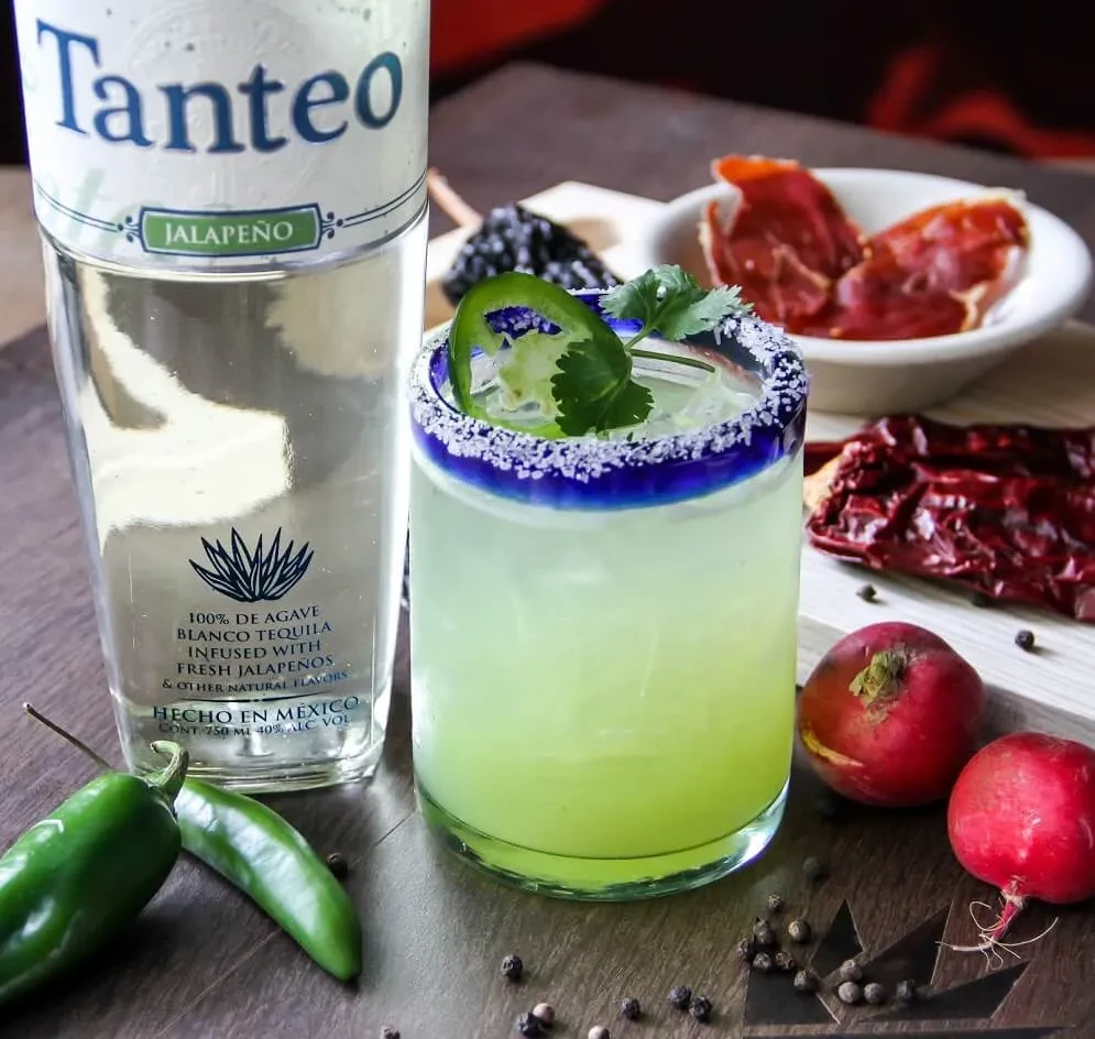 Light green cocktail, blue salted rim, Tanteo Jalapeño tequila, fresh jalapeños.