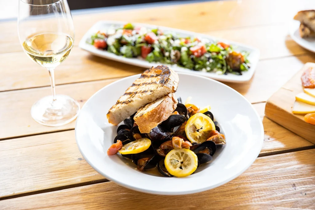 Steamed mussels, grilled bread, wine, fresh salad, and cheese plate.