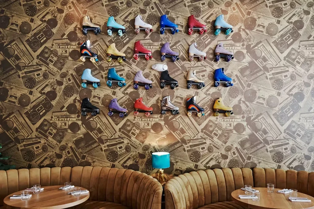 Retro restaurant interior with colorful roller skates and boombox wallpaper.