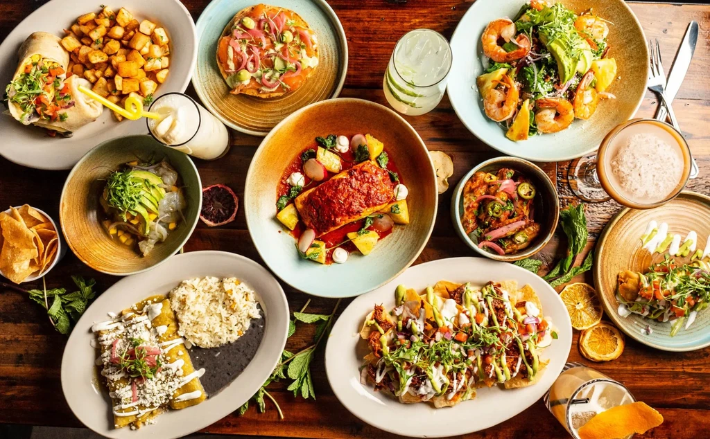 Vibrant overhead spread of diverse Latin American dishes and drinks.
