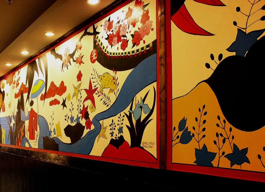 Vibrant, whimsical East Asian mural with pig, boat, and cherry blossoms.