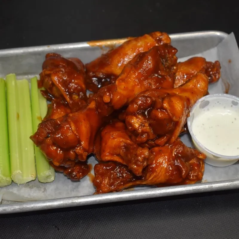 Saucy chicken wings, celery, and creamy white dipping sauce.