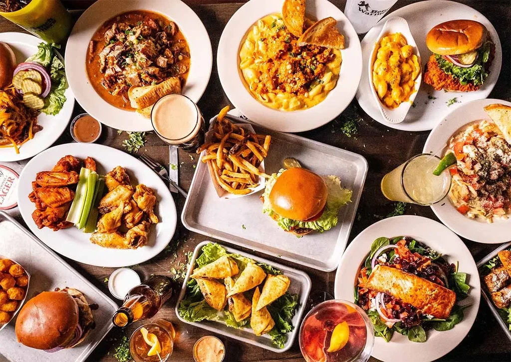 Overhead view of diverse food and drinks on a rustic table.