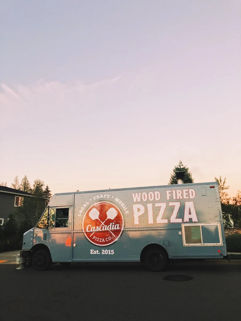 Light blue Cascadia Pizza Co. wood fired pizza food truck.