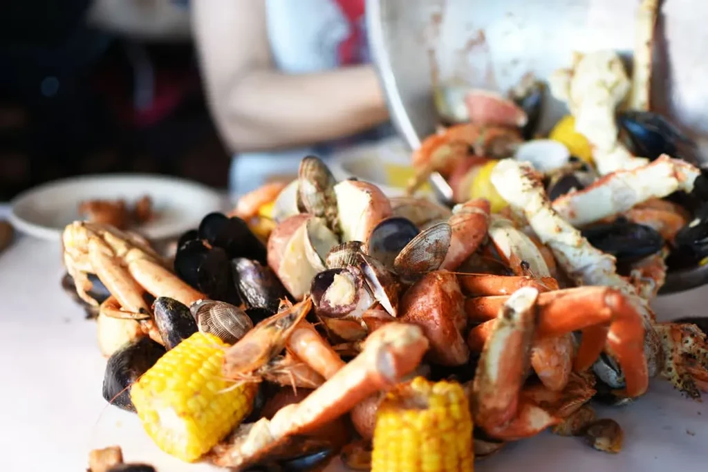 Seafood boil piled high with crab, shrimp, corn, and potatoes.