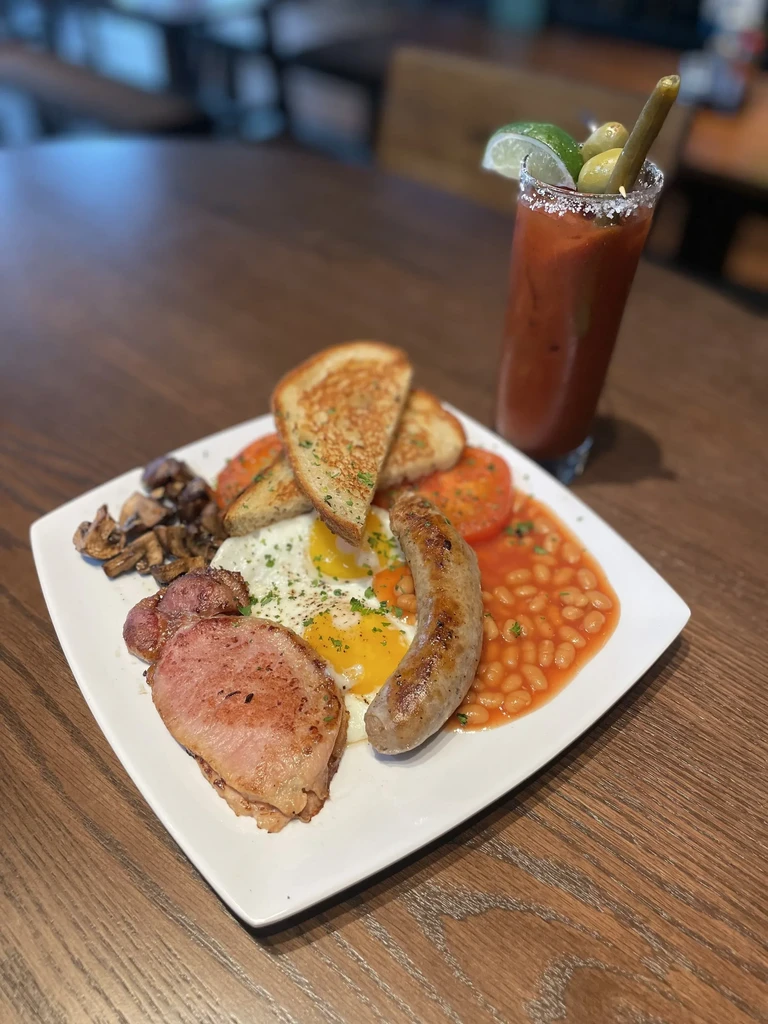A full English breakfast and Bloody Mary cocktail on a restaurant table.