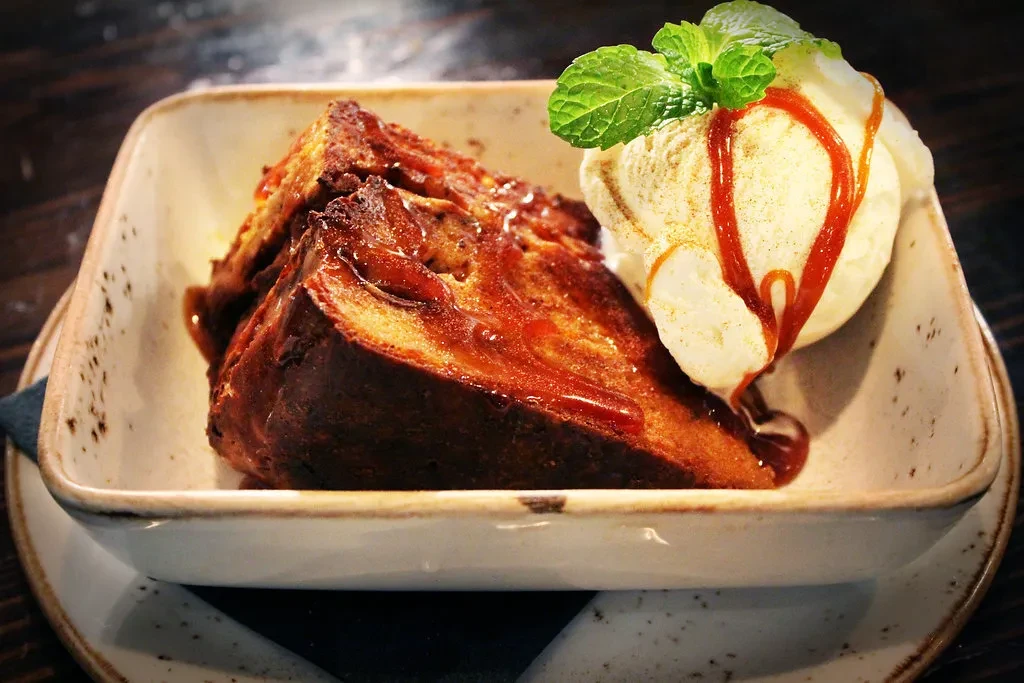 Caramelized French toast, vanilla ice cream, caramel sauce, and mint.
