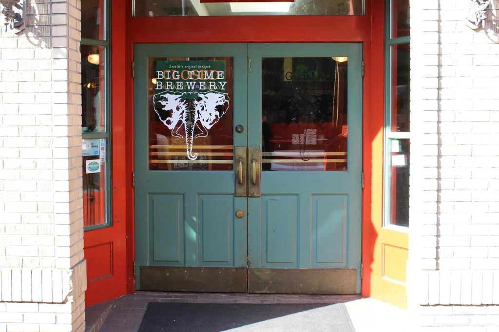 Seattle's Big Time Brewery: teal doors, red frame, white elephant logo.