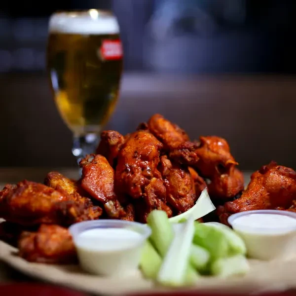 Buffalo wings, creamy dipping sauce, celery, and a Stella beer.