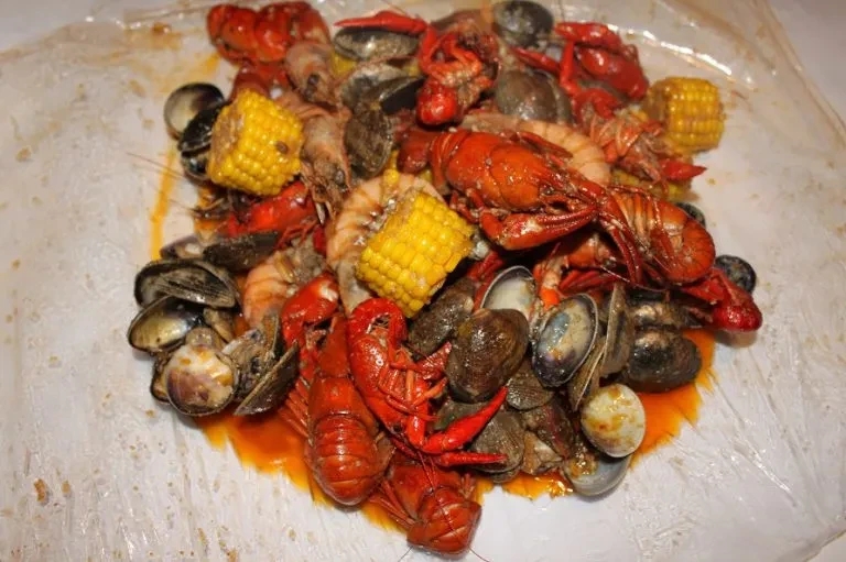 Hearty seafood boil with crawfish, shrimp, clams, and corn.
