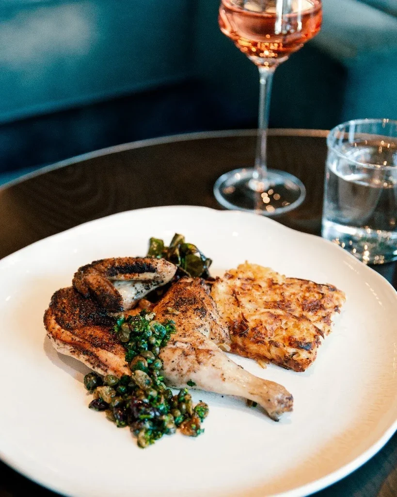 Crispy roasted half-chicken, green salsa, potato gratin, and leafy greens.