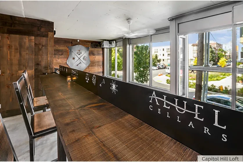 Interior of Aluel Cellars tasting room with a long communal wooden table.