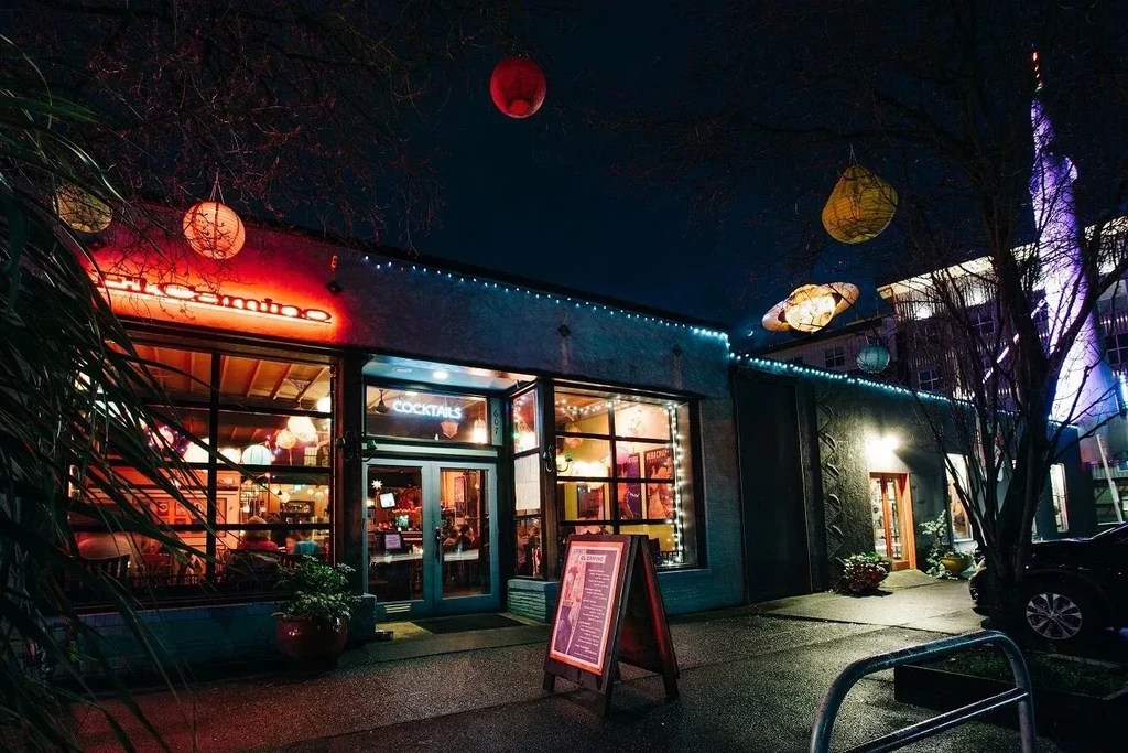El Camino restaurant exterior at night with neon sign and colorful lanterns.